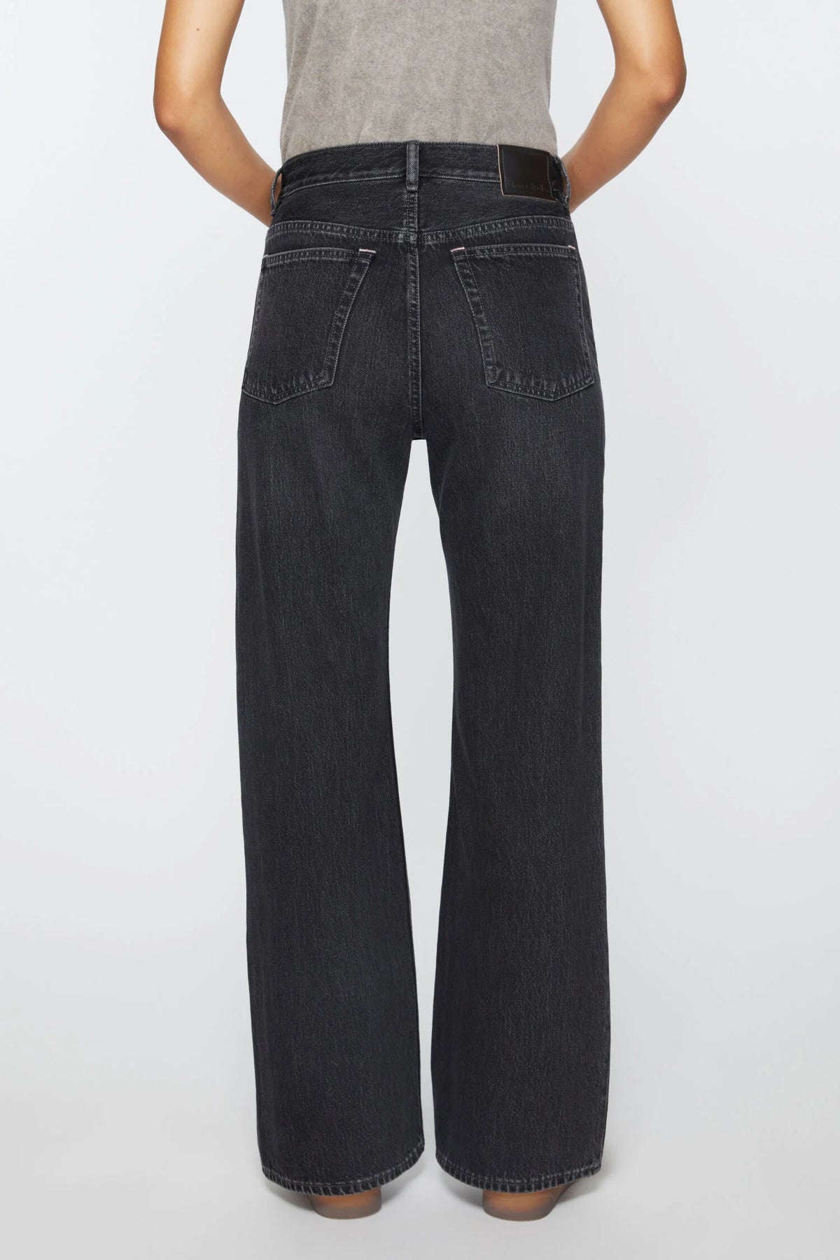 Acne Studios 2021F Jeans in Schwarz melliert, mit einem geraden Bein und einer mittleren Bundhöhe. Dreiviertel Shot, Rückseite.