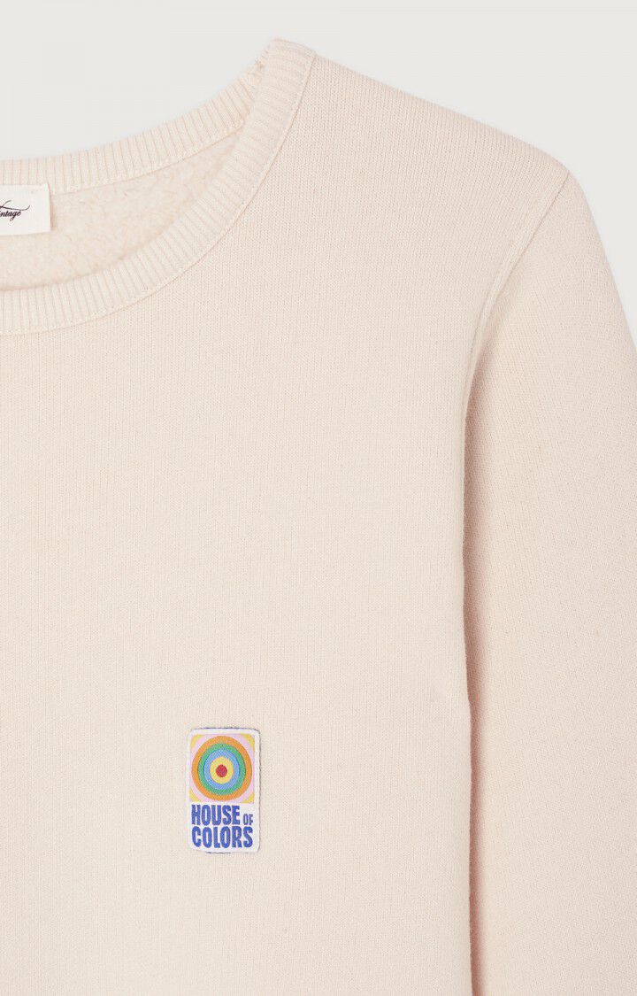 Creme Farbendes Sweatshirt aus weichem Baumwollmaterial, mit Buntem Logodetail an der Linken Brust. Detail Shot Logo. 